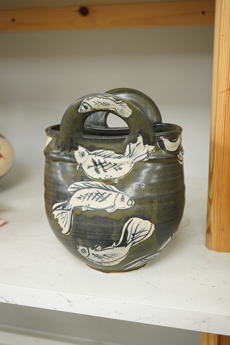 Yolande Beer (Sussex, contemporary), two Studio pottery vessels to include a vase in the form of a basket decorated with fish, largest